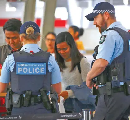  ??  ?? Australian Federal Police officers at Sydney Airport.