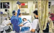  ?? REUTERS ?? Doctors attend to a Covid-19 patient at the Holy Family Hospital in New Delhi.