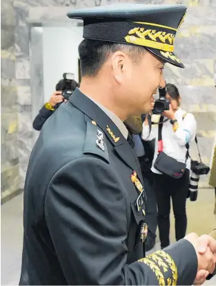  ??  ?? Major General Kim Do Gyun (left) and Lieutenant General An Ik San greet each other at the start of yesterday’s talks.