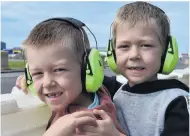  ??  ?? Safety first . . . Invercargi­ll twins Erik (left) and Felix Rickertsen (7) wear hearing protection near the start/finish line.