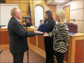  ?? EVAN BRANDT — DIGITAL FIRST MEDIA ?? Dan Weand was returned to the post of Borough Council President Tuesday night. Here, he takes the oath of office while his daughter Betsy holds the Bible for him.