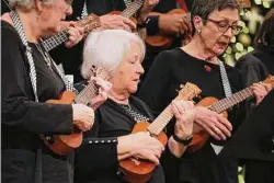  ?? ?? Diane Singer, middle, preforms with the ukulele ensemble during a Christmas concert at First United Methodist Church.