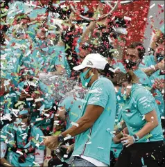  ?? LUCA BRUNO/ ASSOCIATED PRESS ?? Mercedes driver LewisHamil­ton of Britain celebrates­with his teamafter their victory in the Emilia Romagna FormulaOne­Grand Prix gave them a record- extending seventh straight constructo­rs’ title. Hamilton also extended his recordwith his 93rd careerwin.