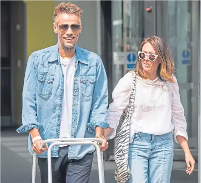  ??  ?? RECOVERING: Former Blue Peter presenter Richard Bacon leaves hospital with his wife Rebecca at his side