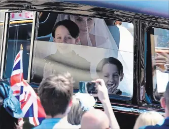  ?? WPA POOL GETTY IMAGES ?? Meghan Markle is driven to St George's Chapel in Windsor Castle along with her page boys, Brian and John Mulroney. The boys captured the mood of the day, social media watchers exclaimed.