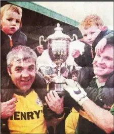  ??  ?? Brothers Richard and Fintan Kennedy celebrate winning the Championsh­ip with Richard’s sons (and now Senior players) Rian and Oisín Kennedy. Pic: Tom Callanan.