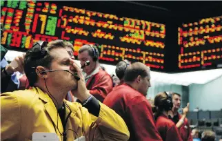  ?? THE ASSOCIATED PRESS ?? Clerk Michael Hill puts his hand on his face in the Euro Dollar options trading pit as stock markets shuddered and then collapsed in a cascading panic during the financial crisis of 2008.