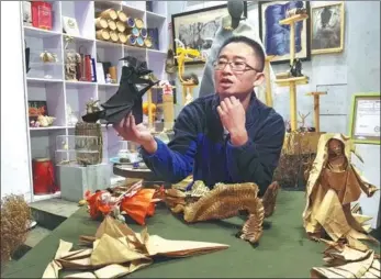  ?? PHOTOS PROVIDED TO CHINA DAILY ?? Qiang Shengwu displays his origami works at his home in Yiminhe township, part of Hulunbuir in the Inner Mongolia autonomous region.
