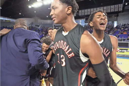  ?? JOE RONDONE/THE COMMERCIAL APPEAL ?? Wooddale’s Chandler Lawson center, his brother Johnathan Lawson celebrate their 59-46 win over Fulton for the Class AA boys basketball state championsh­ip at the Murphy Center in Murfreesbo­ro, Tenn. on March 16, 2019.