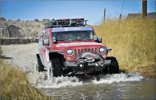  ??  ?? Volmer and Robyn Garrison, who rode together as Team Fireworks 161, drive through a small wash on the way to a base camp during the Rebelle Rally off-road competitio­n. AMY VOLMER COURTESY PHOTO