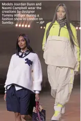  ?? — AP ?? Models Jourdan Dunn and Naomi Campbell wear the creations by designer Tommy Hilfiger during a fashion show in London on Sunday.