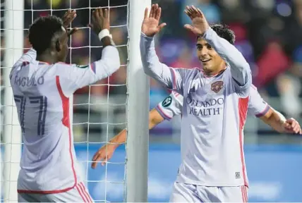  ?? DARRYL DYCK/THE CANADIAN PRESS PHOTOS ?? Orlando City’s Facundo Torres, right, gives thanks to Ivan Angulo, who set him up perfectly to score his second goal on a header Wednesday night in Langford, British Columbia.