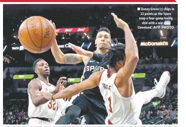  ?? AFP PHOTO ?? Danny Green ( c) chips in 22 points as the Spurs snap a four- game losing skid with a win over Cleveland.