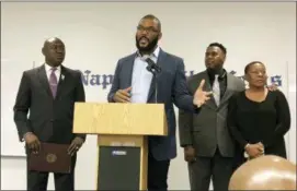  ?? THE ASSOCIATED PRESS ?? Filmmaker Tyler Perry, center, speaks at a press conference announcing a lawsuit against former Collier County Sheriff’s Deputy Steven Calkins, Monday in Naples, Fla.