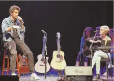  ?? PHOTO BY KELLY DAVIDSON ?? John Mayer, left, gives songwritin­g advice to Callie Sullivan, right, and other students at Berklee.