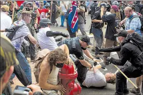  ?? The New York Times/MATT EICH ?? White nationalis­ts clash with counterpro­testers Saturday in a Charlottes­ville, Va., street.