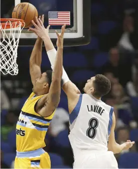  ?? — AP ?? MINNEAPOLI­S: Minnesota Timberwolv­es guard Zach LaVine (8) gets a hand on the ball against Denver Nuggets guard Gary Harris, right, in the first half of an NBA basketball game, in Minneapoli­s.