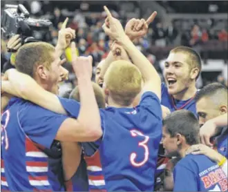  ?? MARC PENDLETON / STAFF ?? It’s a celebratio­n for Colton Linkous (left) and Damion Cook (top right). as unbeaten Tri-Village defeats Harvest Prep 48-46 to win the boys Division IV state championsh­ip on Saturday.