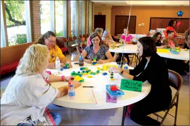  ?? Michael Shine/NewsTimes ?? Legos and learning: Above, LeeAnn Davis from Camden ABC, Stephanie Sliva from Harmony Grove ABC, Alicia Neely from Retta Brown ABC and Christie Galusha from Norphlet ABC used a kit of larger Legos to craft sculptures based on prompts such as to make something that can fly or a form of transporta­tion.Below, Melissa Slaughter from Parkers Chapel ABC and Tara Morgan from Parkers Chapel ABC, perform an activity with their Legos focused on communicat­ion. The two sat with their backs to each other as one of them describing what they were building so the other could build the same thing.