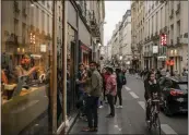  ?? DMITRY KOSTYUKOV — THE NEW YORK TIMES ?? People stand in line to enter a restaurant in Paris in May.