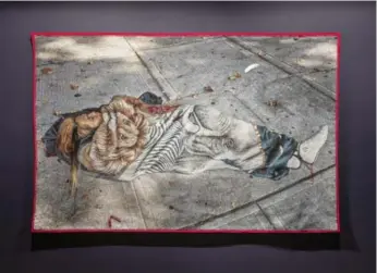  ?? TONI HAFKENSCHE­ID/THE ART MUSEUM ?? Rebecca Belmore’s Dream Catcher shows an Indigenous woman unconsciou­s on a sidewalk.