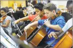  ?? Carol Kaliff / Hearst Connecticu­t Media ?? Nick Gondinho,10, left center, and Gianni Dimeglio, 11, play the cello in The Bethel Middle School orchestra. The middle school’s sixth grade is the largest in the district with 275 students.