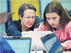  ?? STEPHEN DUNN/ASSOCIATED PRESS ?? Jennifer Rocca, left, a teacher at Brookfield High School in Connecticu­t, works with Ariana Mamudi, 14. Rocca’s Digital Student class is required and teaches media literacy skills, like how to scrutinize online informatio­n.
