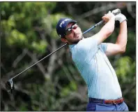  ?? AP/CHARLIE NEIBERGALL ?? Former Arkansas Razorbacks golfer Andrew Landry hits off the second tee Saturday during the third round of the PGA’s John Deere Classic in Silvis, Ill. Landry shot a 4-under 67 and shares the tournament lead with Cameron Tringale going into today’s final round.