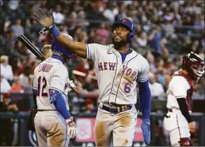  ?? Christian Petersen / Getty Images ?? The Mets’ Starling Marte reacts after scoring a run against the Diamondbac­ks during the sixth inning on Sunday.