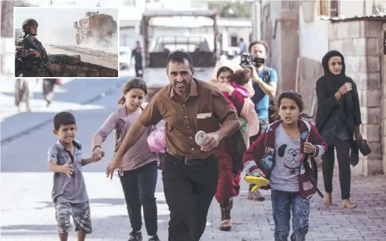  ?? Pictures: AP/GETTY ?? FLEEING: People in the town of Akcakale, Turkey run for cover after mortars are fired from Syria, and (inset) Turkish armoured vehicles enter Syria.