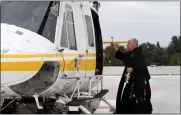  ?? BRITTANY MURRAY — STAFF PHOTOGRAPH­ER ?? Richard Hire, director of spiritual care at St. Francis Medical Center, blesses an L.A. County helicopter as part of National Emergency Medical Services Week in Lynwood on Tuesday.