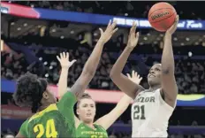 ?? Mike Ehrmann / Getty Images ?? Kalani Brown, Baylor’s 6-foot-7 center, shoots against Ruthy Hebard, left, and Erin Boley of Oregon on Friday.