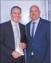  ??  ?? AMMA chief executive Steve Knott presents the Health and Wellbeing award to with Compass Group Australia executive director (offshore and remote) John Sheridan.