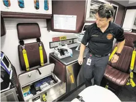  ?? Brett Coomer / Houston Chronicle ?? Lt. John Hanna, a paramedic with Sugar Land EMS, stands in the back of an ambulance at Sugar Land Fire Station 1 on Tuesday, June 30, in Sugar Land. The city fire department is operating its ambulances without controlled substances like painkiller­s and...