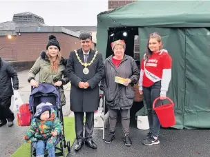  ??  ?? Hyndburn Mayor Mohammad Ayub pictured with residents at the Rishton Christmas Lights Switch and a certain red-suited gentleman gets in on the action