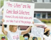  ?? ?? Betsy Hunt, of Scherervil­le, holds a sign during a demonstrat­ion in support of abortion rights at the corner of Indianapol­is Boulevard and Ridge Road in Highland on Saturday.