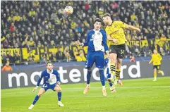  ?? AFP ?? Dortmund’s Niclas Fuellkrug, right, heads the ball to score his team’s third goal against Atletico Madrid.