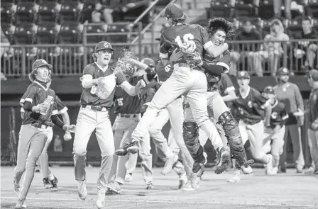  ?? HAYNE PALMOUR IV FOR THE U-T ?? Sage Creek pitcher Luke Caruso (16) jumps into the arms of catcher Sean Saiki as they and teammates celebrate the Division 2 title.