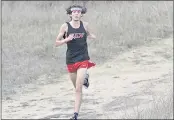  ?? ?? San Lorenzo Valley High’s Marco Evans runs in a cross country meet against Scotts Valley in Felton on Thursday. He’s wearing a headband to honor late teammate Cash Ebright, who always wore a headband while running.