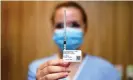  ?? Photograph: Dan Peled/AAP ?? A nurse holds up a syringe containing the Pfizer vaccine in Brisbane.