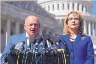  ?? SUSAN WALSH/ASSOCIATED PRESS ?? Former Rep. Gabrielle Giffords, D-Ariz., listens as her husband Mark Kelly speaks in Washington in 2017. Kelly, a former astronaut, plans to run for the Senate.