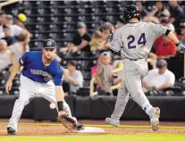  ?? JIM THOMPSON/JOURNAL ?? Reno’s Braden Shipley (24) beats the throw to first as Albuquerqu­e’s Ben Paulsen fields a low throw during the Aces’ win over the Isotopes on Friday night.