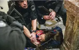  ?? Victor J. Blue / Bloomberg ?? A woman lies on the ground after being shot during rioting at the Capitol, which ended up being placed on lockdown. The woman later died.