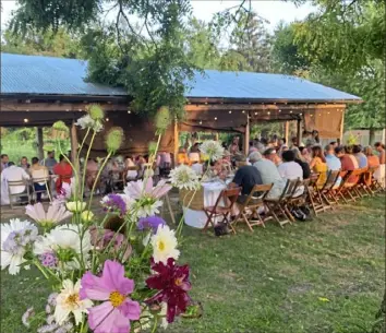  ?? Churchview Farm ?? Diners sit close to one another duirng a farm dinner at Churchview Farm last year. Because the COVID-19 recommenda­tions, the farm in Baldwin Borough has come up with a new program called Pickup Pop Ups. Guests can still go to the farm and talk to the chef and farmer, but instead of dining at the farm, they will be taking the meal home. of