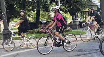  ?? Lori Van Buren / Times Union ?? Allison Joseph, founder of the local chapter of Black Girls Do Bike organizati­on, center, rides out of Riverfront Park in 2020 in Troy. She partnered with Troy 4 Black Lives and Troy Bike Rescue to raise funds for Black Lives Matter and low income children who can not afford bikes.