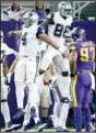  ?? AP/JIM MONE ?? Dallas quarterbac­k Dak Prescott (left) celebrates with wide receiver Dez Bryant (center) in front of Minnesota defensive end Everson Griffen after Bryant’s touchdown gave the Cowboys the lead for good in their 17-15 victory Thursday night.