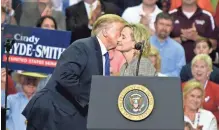  ?? SHELLEY COMMERCIAL ?? President Donald Trump kisses Mississipp­i Sen. Cindy Hyde-Smith during a rally at the Landers Center in Southaven on Oct. 2. MAYS / THE