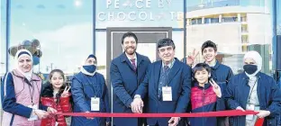  ?? PHOTO COURTESY OF APPLEHEAD ?? Tareq Hadhad and his family cut the ribbon to officially mark the opening of a new shop in downtown Halifax. From left, Alaa Isam Eddin Hudhud, Sana Al Kadri, Shahnaz Naisa, Tareq Hadhad, Isameddin Hadhad, Omar Al Kadri, Ahmad Hadhad and Taghrid Hadhad.