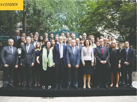  ?? FLORENCE LO / REUTERS ?? Jim Nickel, charge d'affaires of the Canadian Embassy in Beijing, fifth from left, stands with diplomats from 25 countries for a group photo at the
embassy in China's capital Wednesday, as a court in Dandong sentenced Michael Spavor to 11 years in prison in a trial that drew heavy criticism.