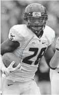  ?? ROB CARR/GETTY PHOTO ?? West Virginia’s Terence Garvin returns an intercepti­on for a touchdown in the Mountainee­rs’ victory over Maryland in September 2011.